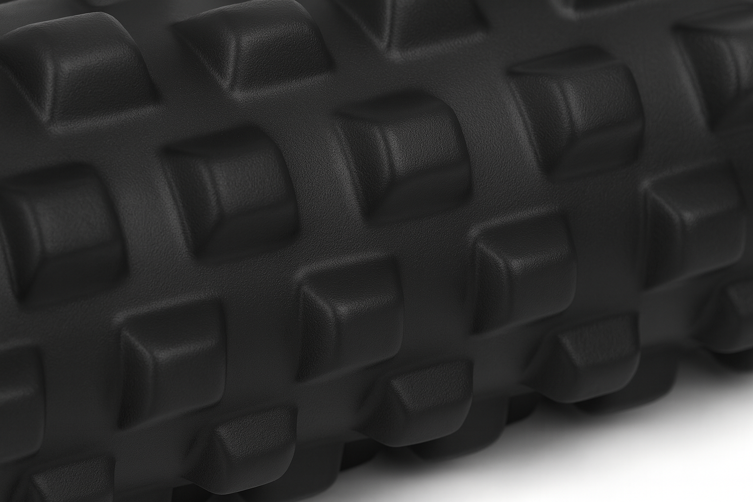 Zbliżenie na strukturę powierzchni czarnego rollera do masażu z wypustkami.